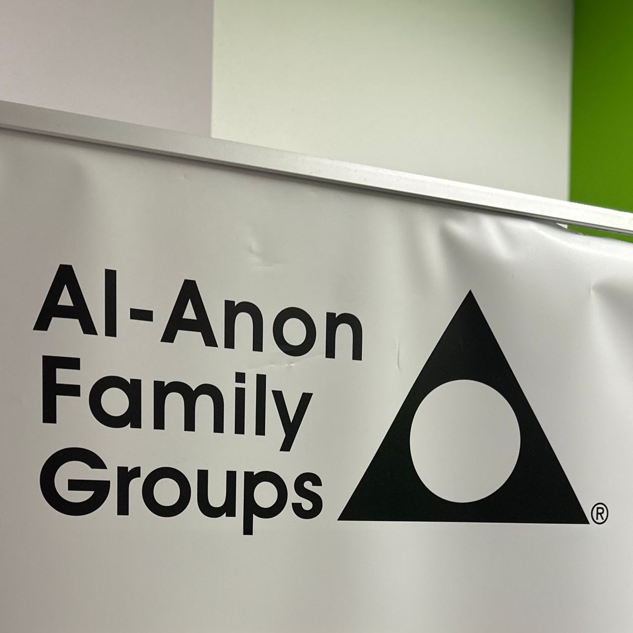 A pull-up banner in a hospital showing the headline "AI Anon"